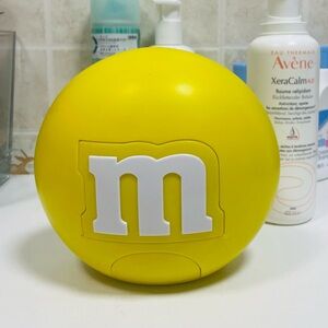 Vintage collectible M&M’s lentl-shaped candy dispenser yellow